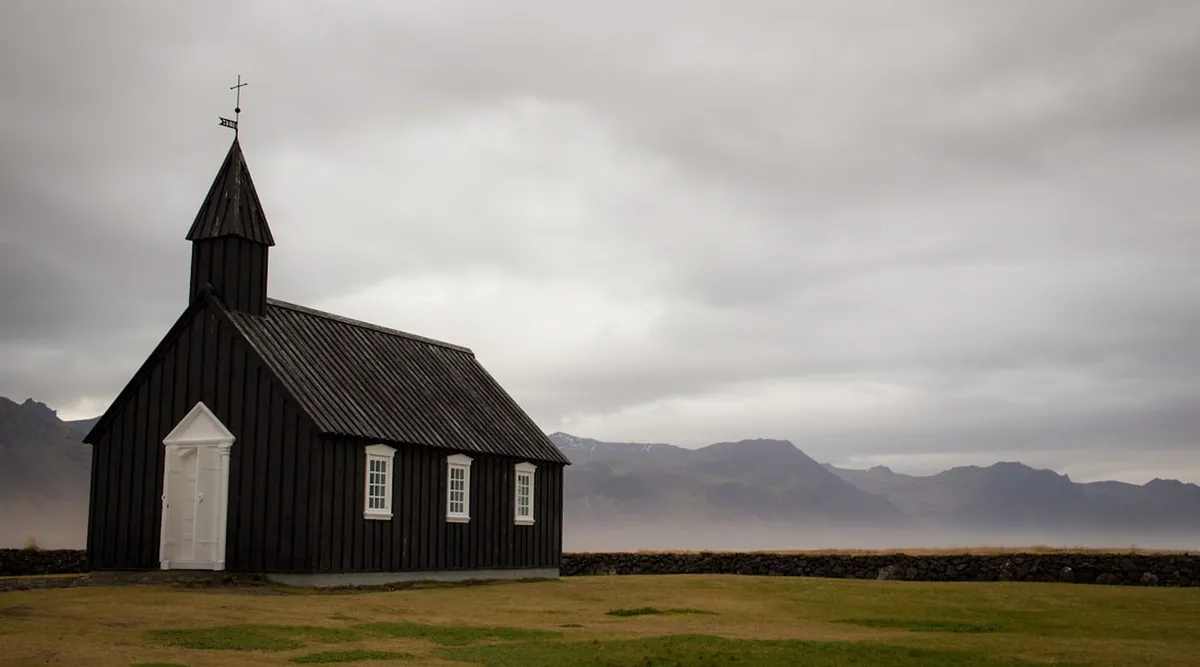 Budir black church on Snaefellsnes peninsula with mountains